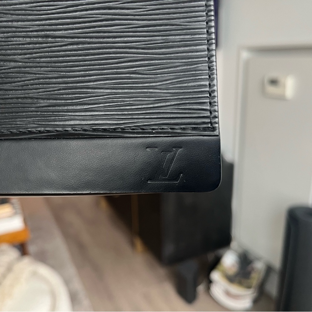 Louis Vuitton black leather clutch.